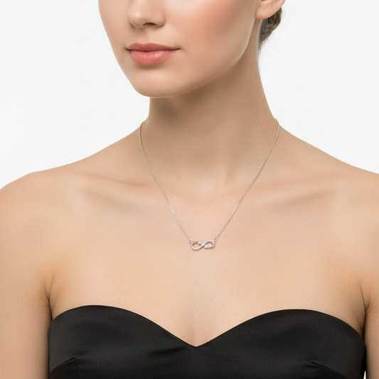 Silver necklace with a unique pendant in a black box on a red fabric background