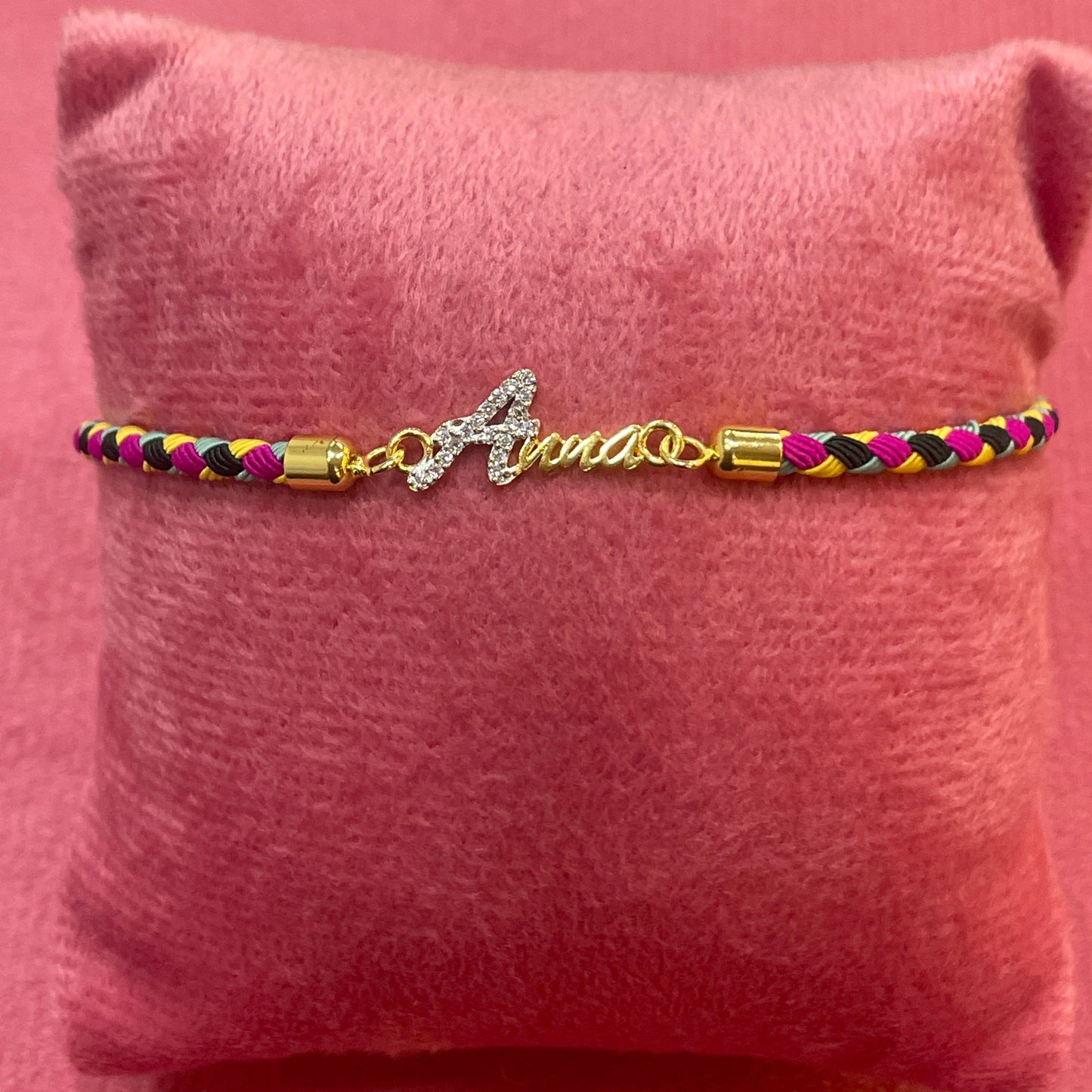 Gold-Plated Rakhi | CZ Name Script Charm on Multicolour Braided Silk Thread
