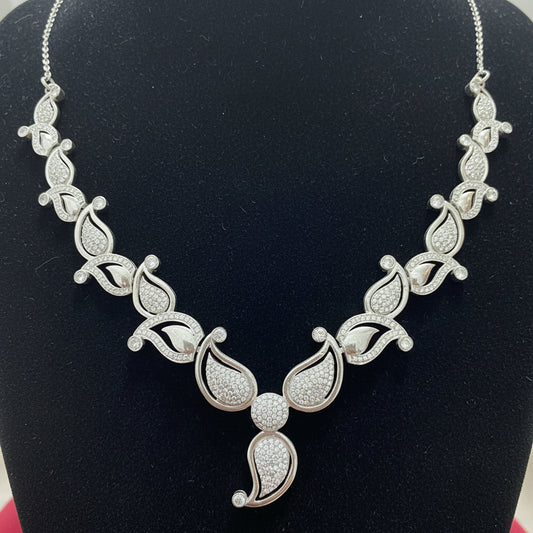 Silver necklace with intricate design on a red velvet background