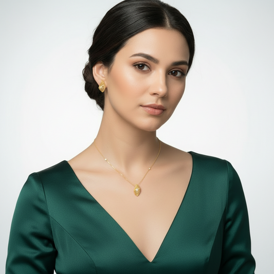 Woman wearing gold jewelry against a plain background