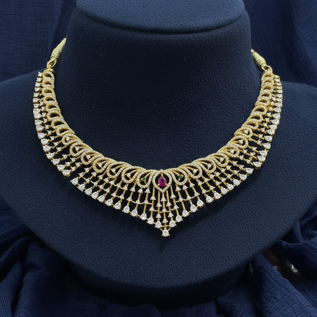 Gold necklace with a red gemstone on a red fabric background