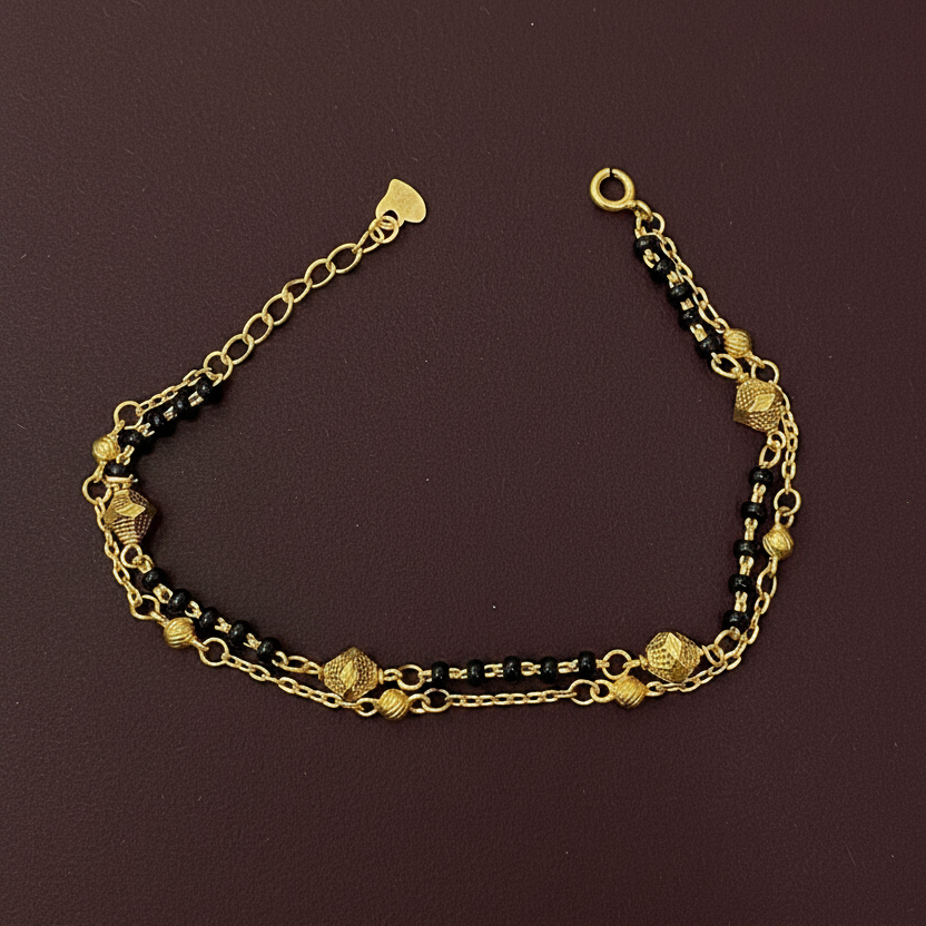 Gold chain bracelet on a red fabric background