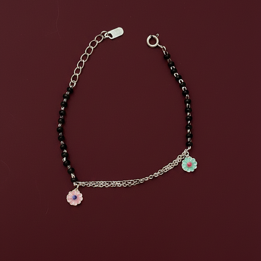 Bracelet with floral charms on a red fabric background