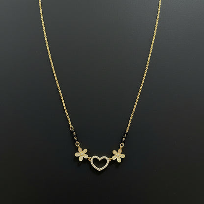 Gold necklace with floral designs on a red background