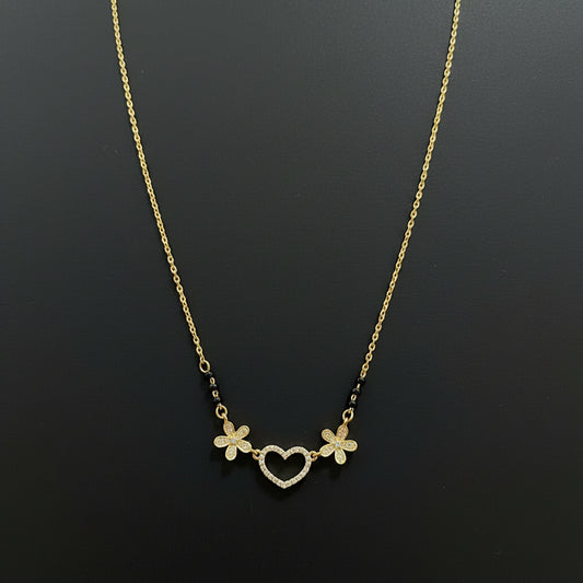Gold necklace with floral designs on a red background