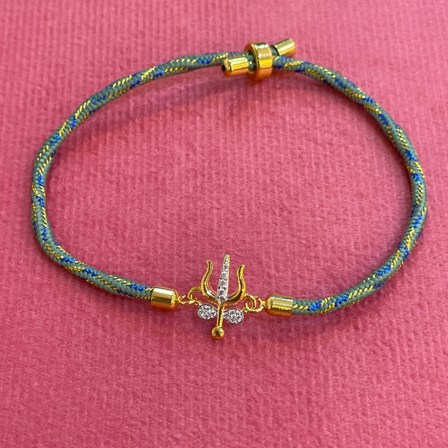 Silver Trishul Rakhi for Brother | Gold Plated Trishul Charm with CZ Stones on Teal Thread