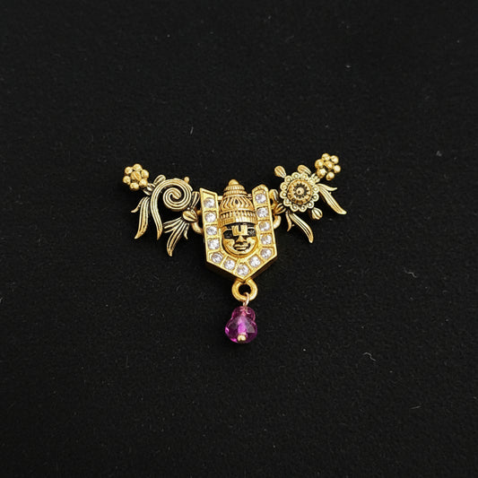 Decorative brooch with intricate design on a blue textured background