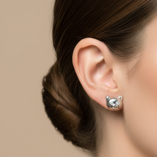 Close-up of a woman wearing a diamond earring against a beige background