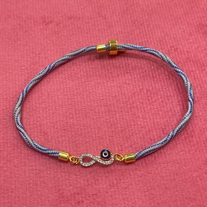Gold-Plated Rakhi for Brother | CZ Infinity & Evil Eye Charm on Blue Silk Thread