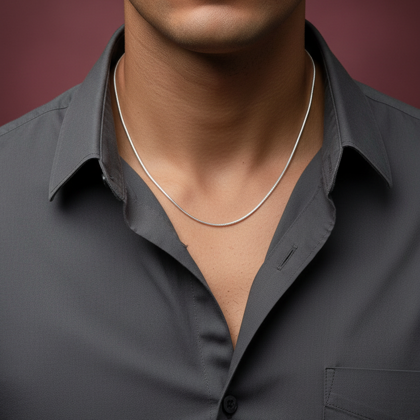 Man wearing a dark gray shirt with a plain background
