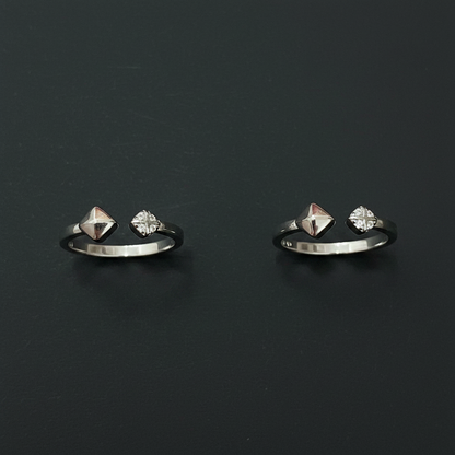 Silver jewelry with dangling charms on a pink textured fabric background