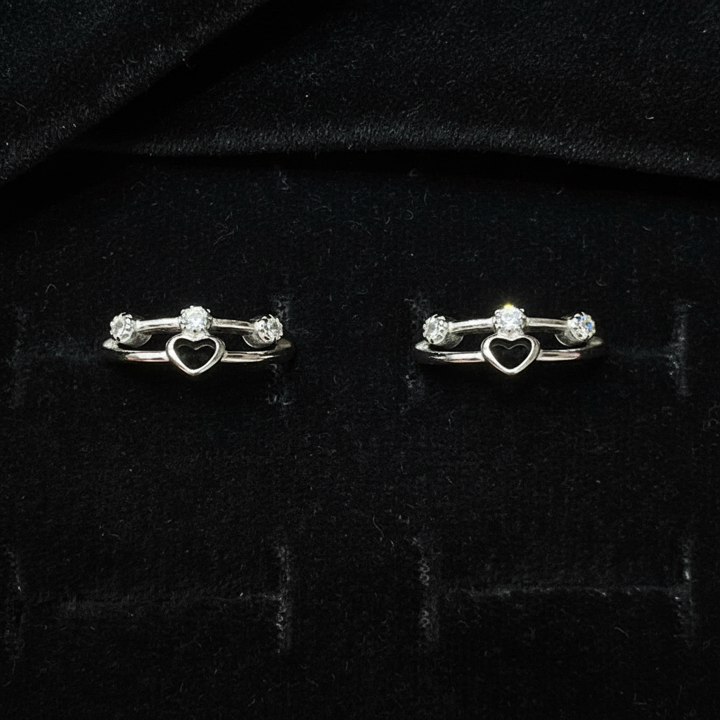 Silver key-shaped earrings on a pink fabric background