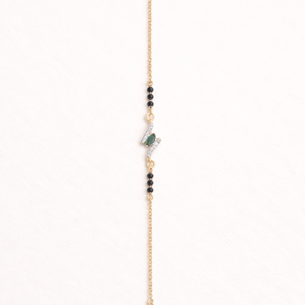 Gold bracelet with beads on a white background