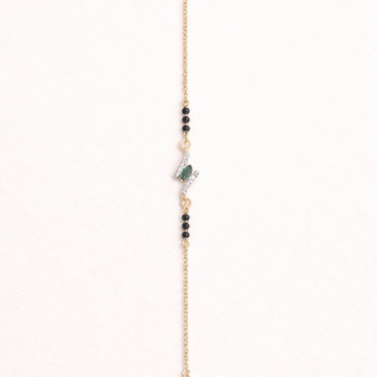 Gold bracelet with beads on a white background