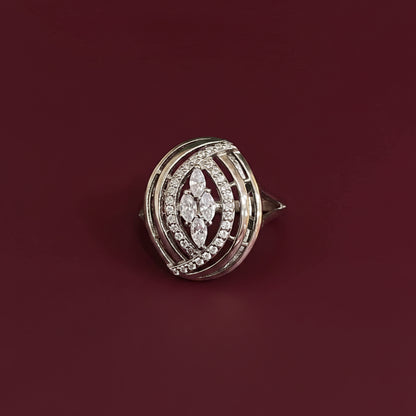 Diamond-studded brooch on a textured blue and red fabric background