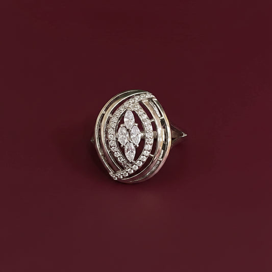 Diamond-studded brooch on a textured blue and red fabric background