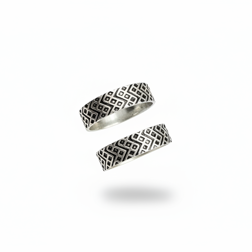 Two silver rings with geometric patterns on a white background