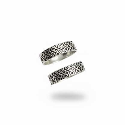 Two silver rings with geometric patterns on a white background