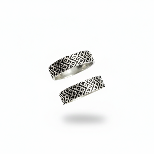 Two silver rings with geometric patterns on a white background