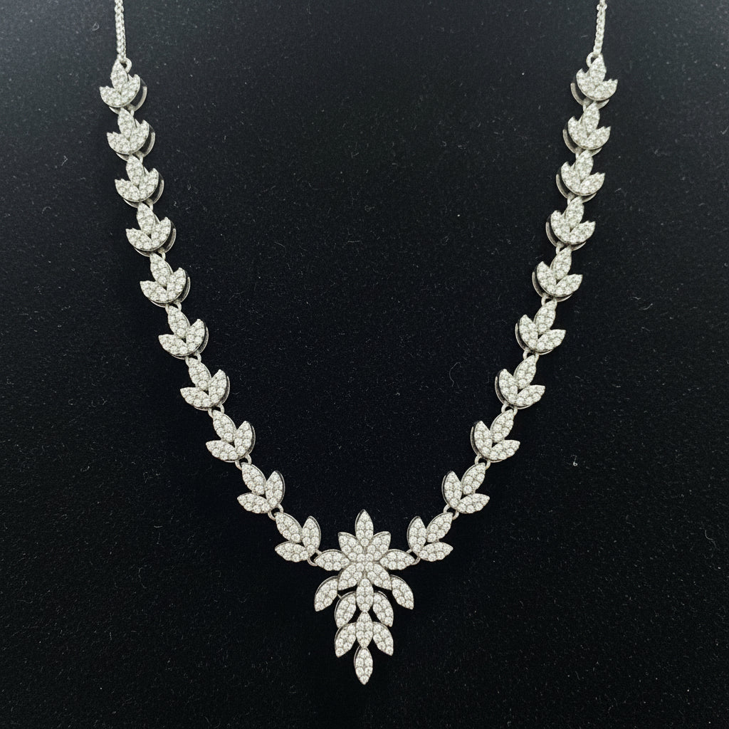 Silver necklace with floral design on a red velvet background