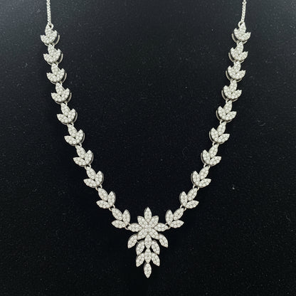 Silver necklace with floral design on a red velvet background