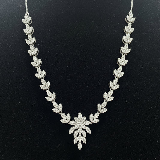 Silver necklace with floral design on a red velvet background