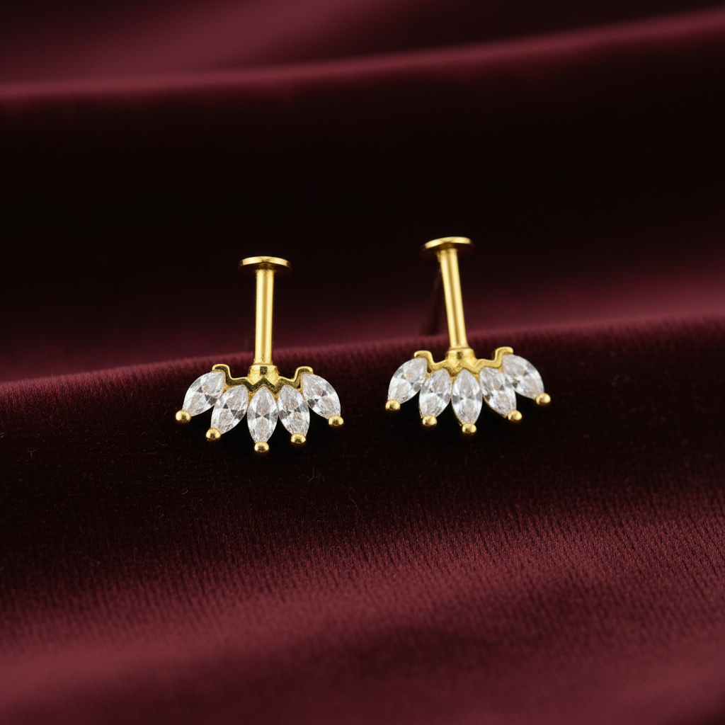 92.5 silver Gold plating bugadi earrings with clear stones on a maroon fabric background