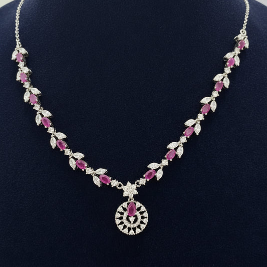 Necklace with pink and clear stones on a red velvet background