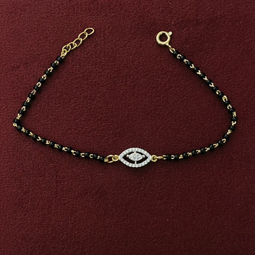 Black and gold beaded bracelet on a red fabric background