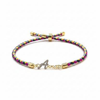 Gold-Plated Rakhi | CZ Name Script Charm on Multicolour Braided Silk Thread
