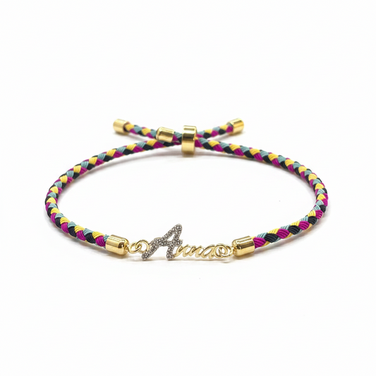 Gold-Plated Rakhi | CZ Name Script Charm on Multicolour Braided Silk Thread