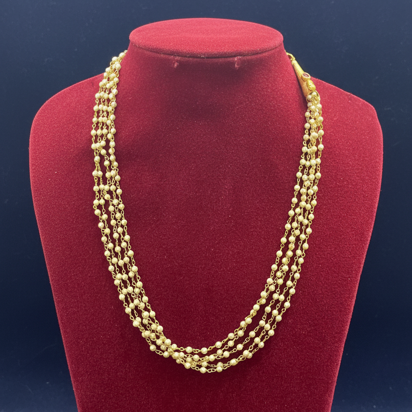 Gold necklace on a red fabric background