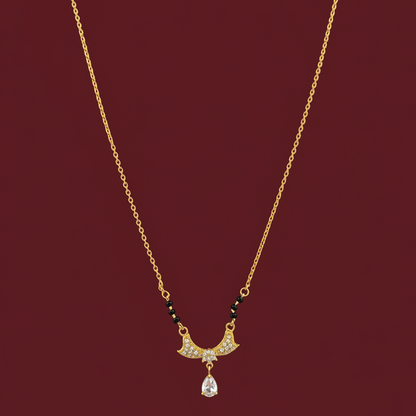 Gold necklace with a pendant on a red velvet surface