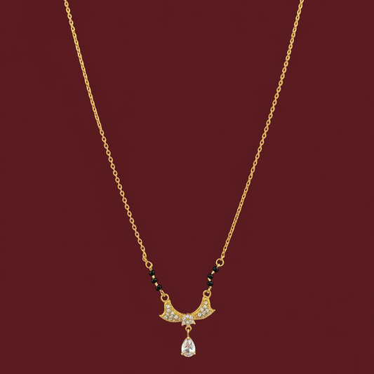Gold necklace with a pendant on a red velvet surface