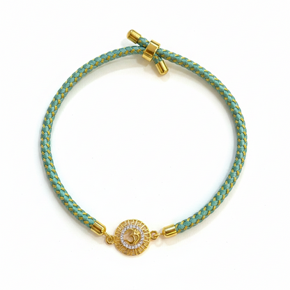 Silver Om Rakhi for Brother | Gold Plated CZ Charm with Teal Thread