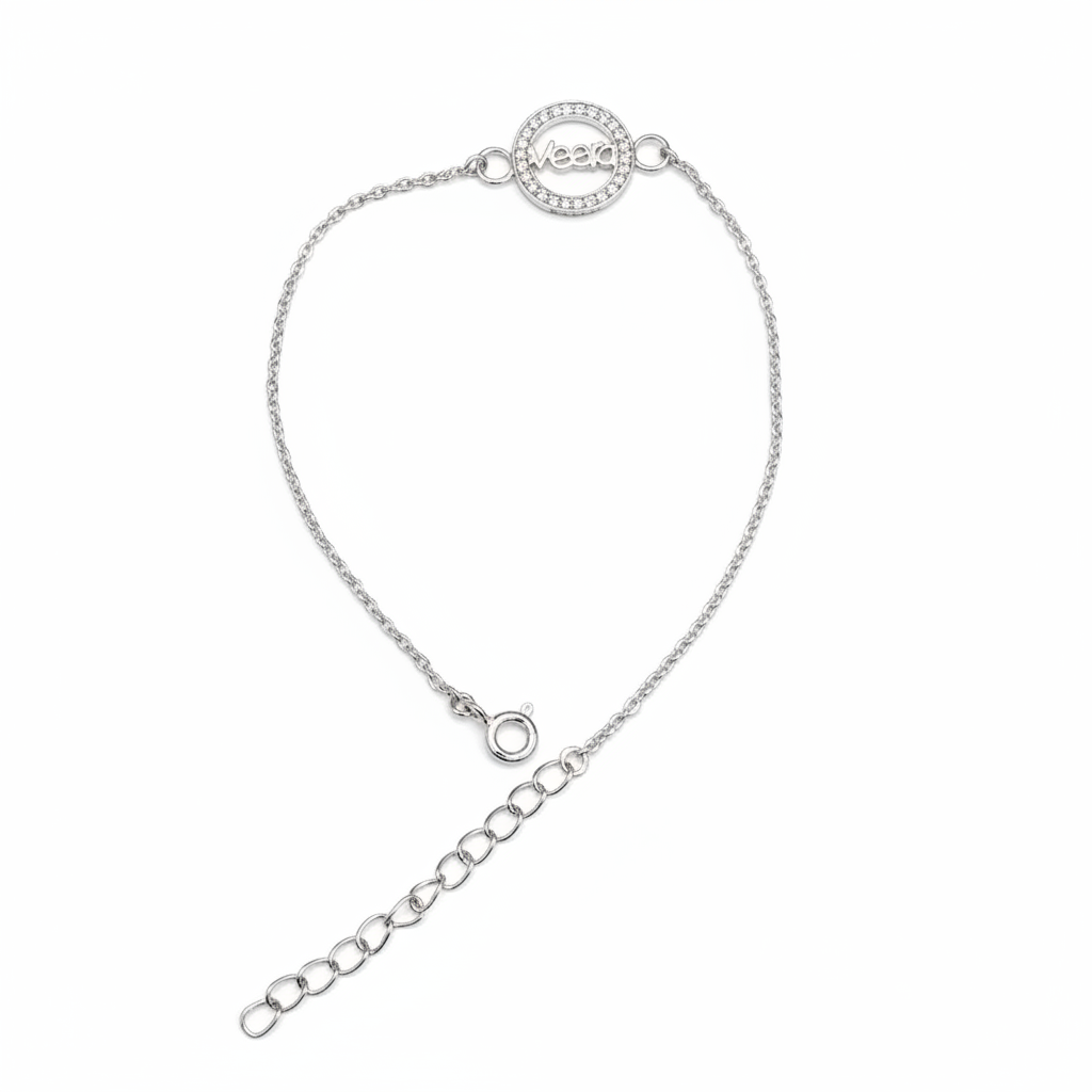 A delicate silver chain bracelet with a circular pavé-set logo charm and an adjustable extender chain, shown on a plain white background.