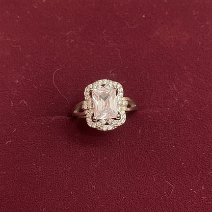 Diamond ring on a green fabric background