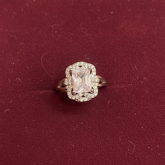 Diamond ring on a green fabric background