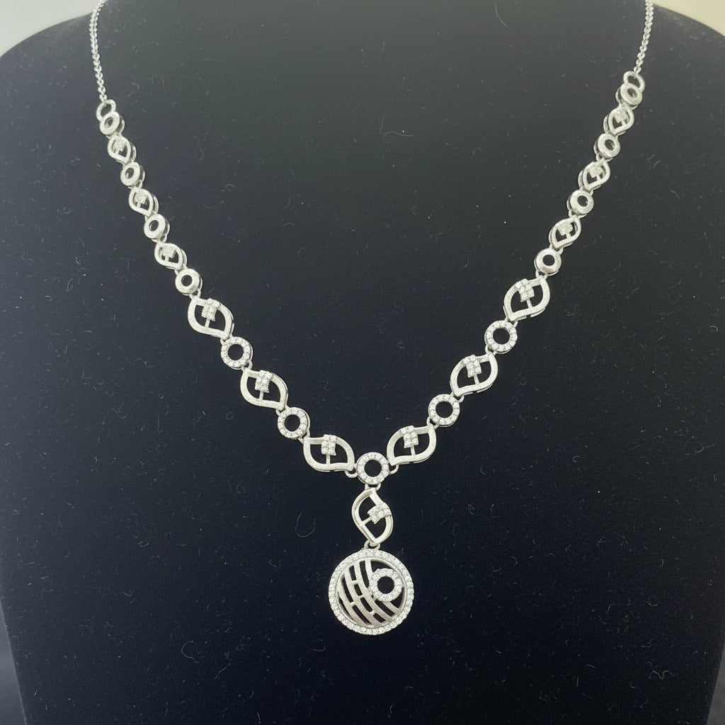 Silver necklace with a pendant on a red velvet surface