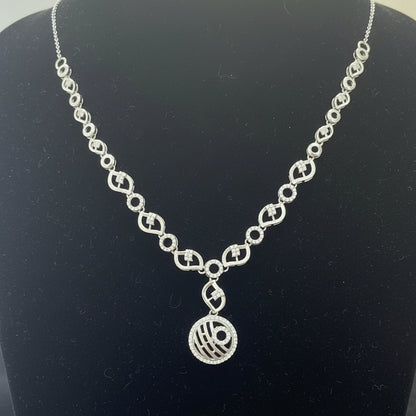 Silver necklace with a pendant on a red velvet surface