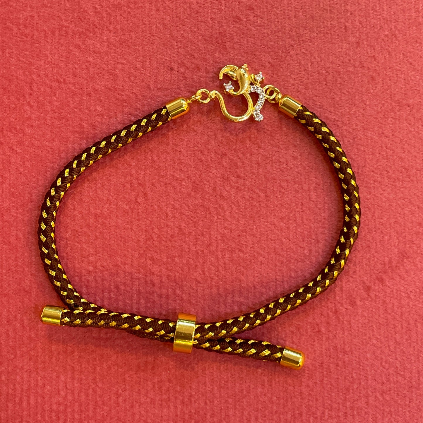 Silver Om Rakhi for Brother | Gold Plated Om Clasp on Brown & Gold Braided Thread