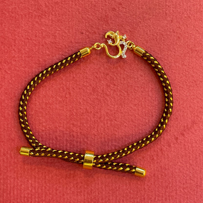 Silver Om Rakhi for Brother | Gold Plated Om Clasp on Brown & Gold Braided Thread