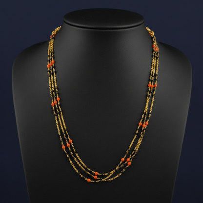 Necklace with red and gold beads on a red fabric background