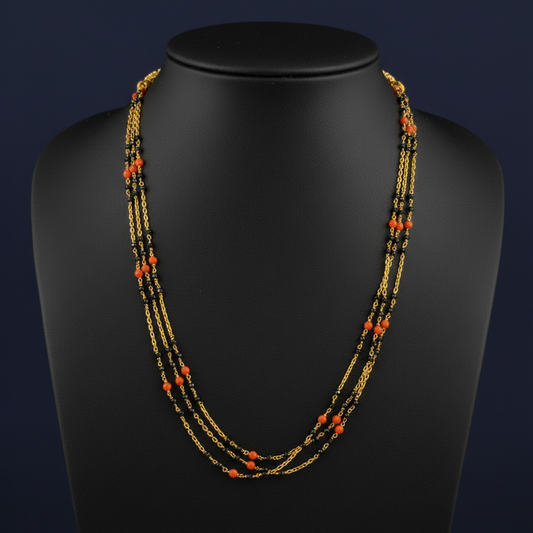 Necklace with red and gold beads on a red fabric background