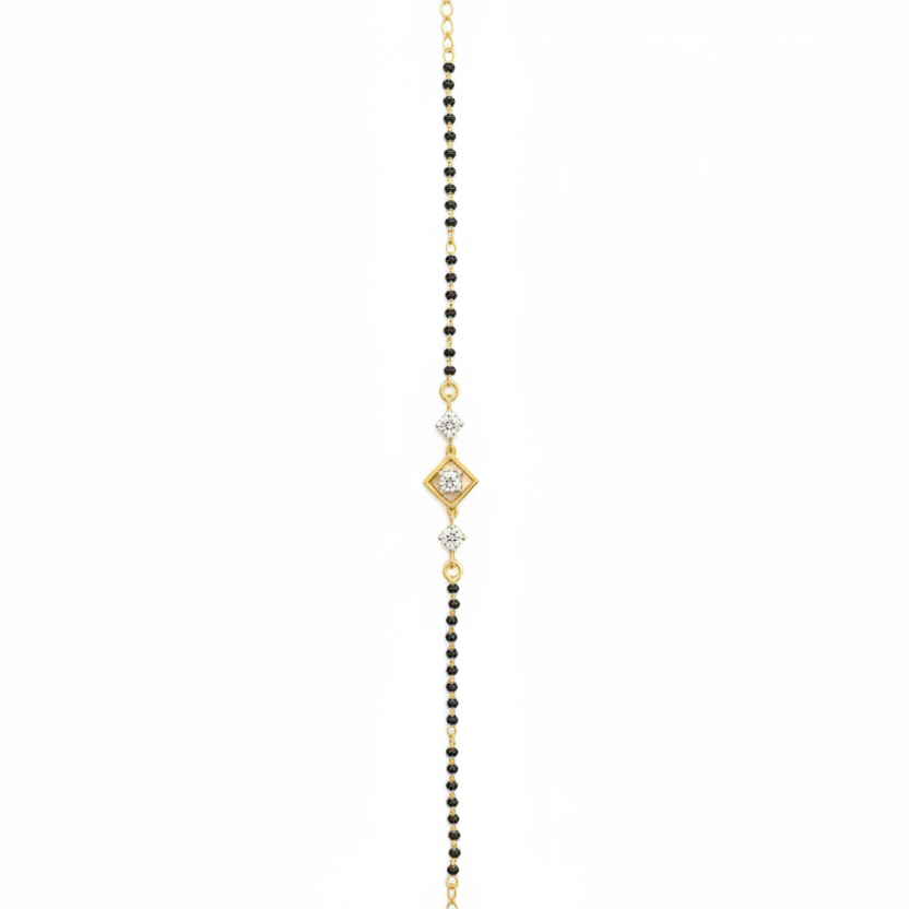 Delicate gold and black beaded necklace on a white background