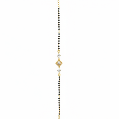 Delicate gold and black beaded necklace on a white background