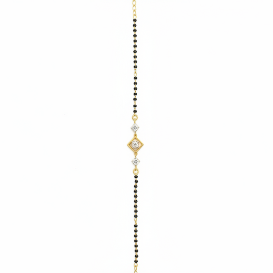 Delicate gold and black beaded necklace on a white background