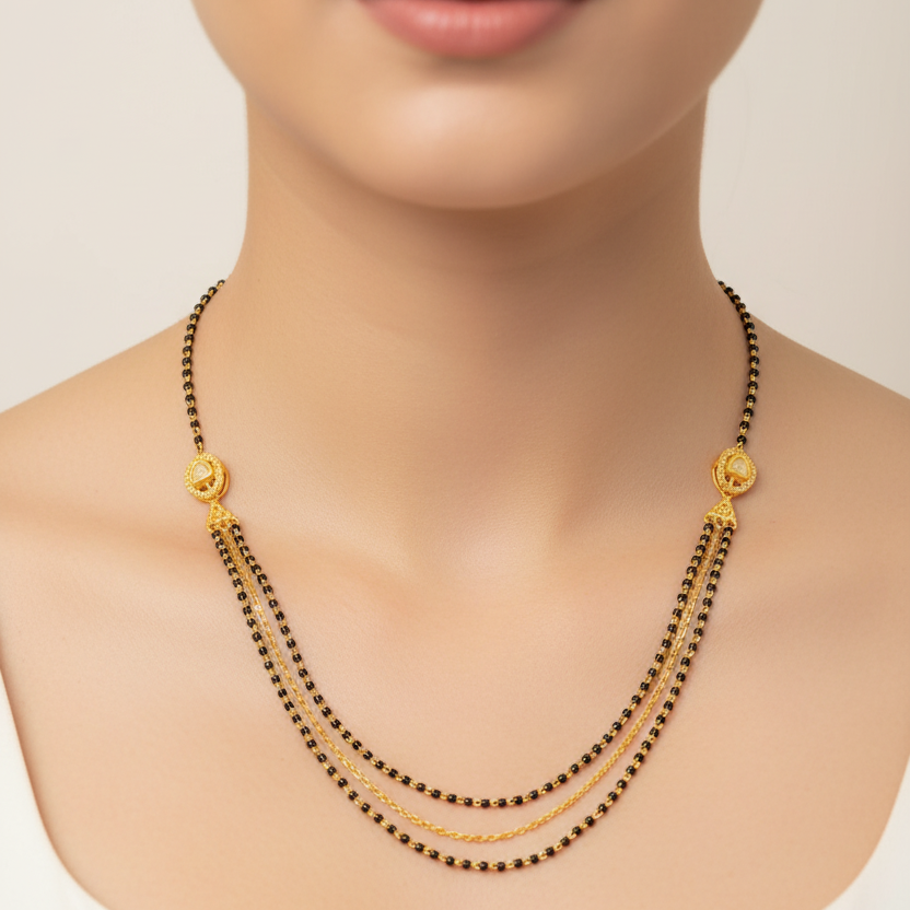 Gold and black beaded necklace on a mannequin