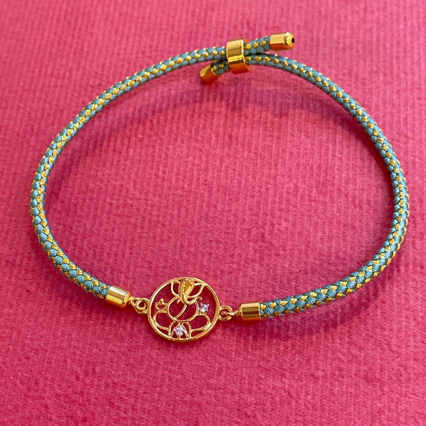 Silver Ganesha Rakhi for Brother | Gold Plated Ganesh Charm with CZ Stones on Teal Thread