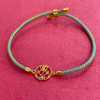 Silver Ganesha Rakhi for Brother | Gold Plated Ganesh Charm with CZ Stones on Teal Thread